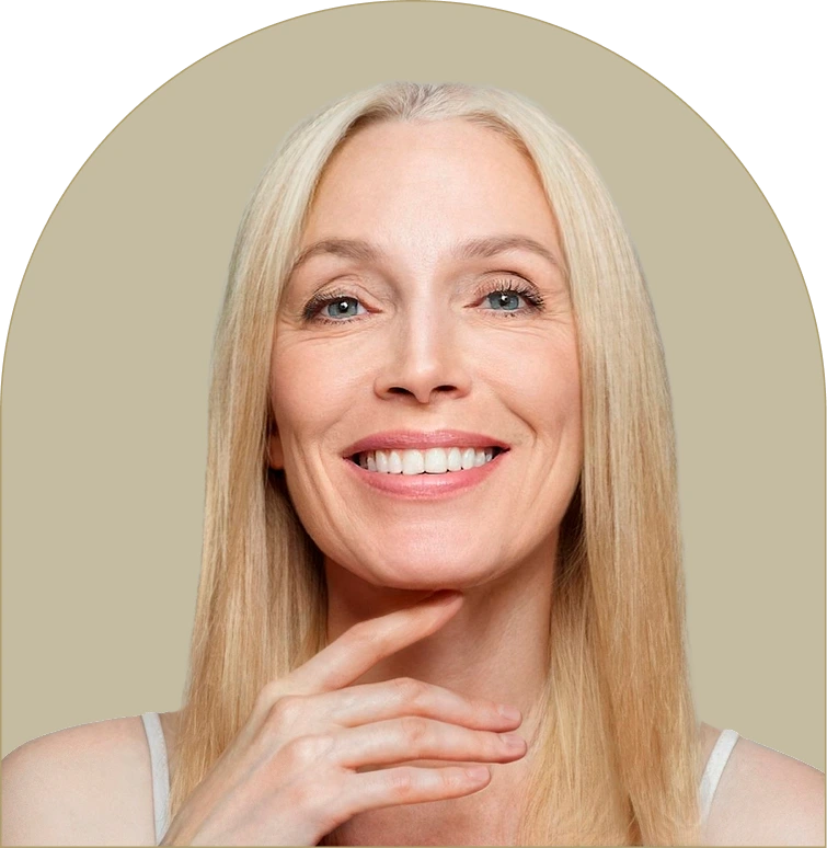 Mature woman with blonde hair smiling, touching her chin with her hand