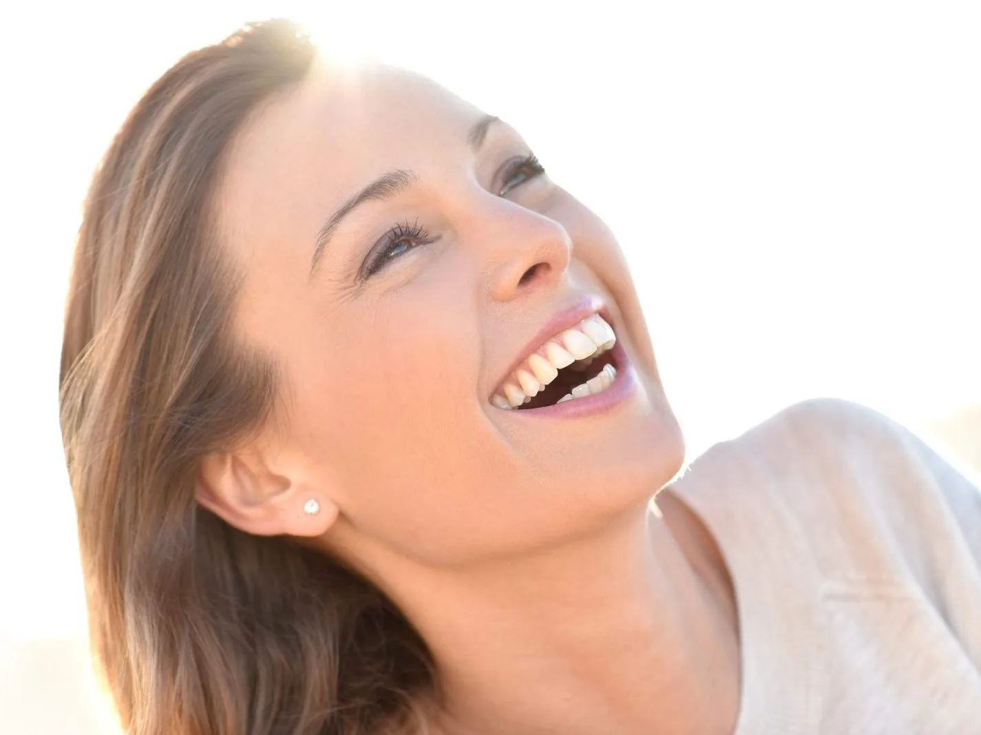 Woman smiling with bright white teeth and glowing skin