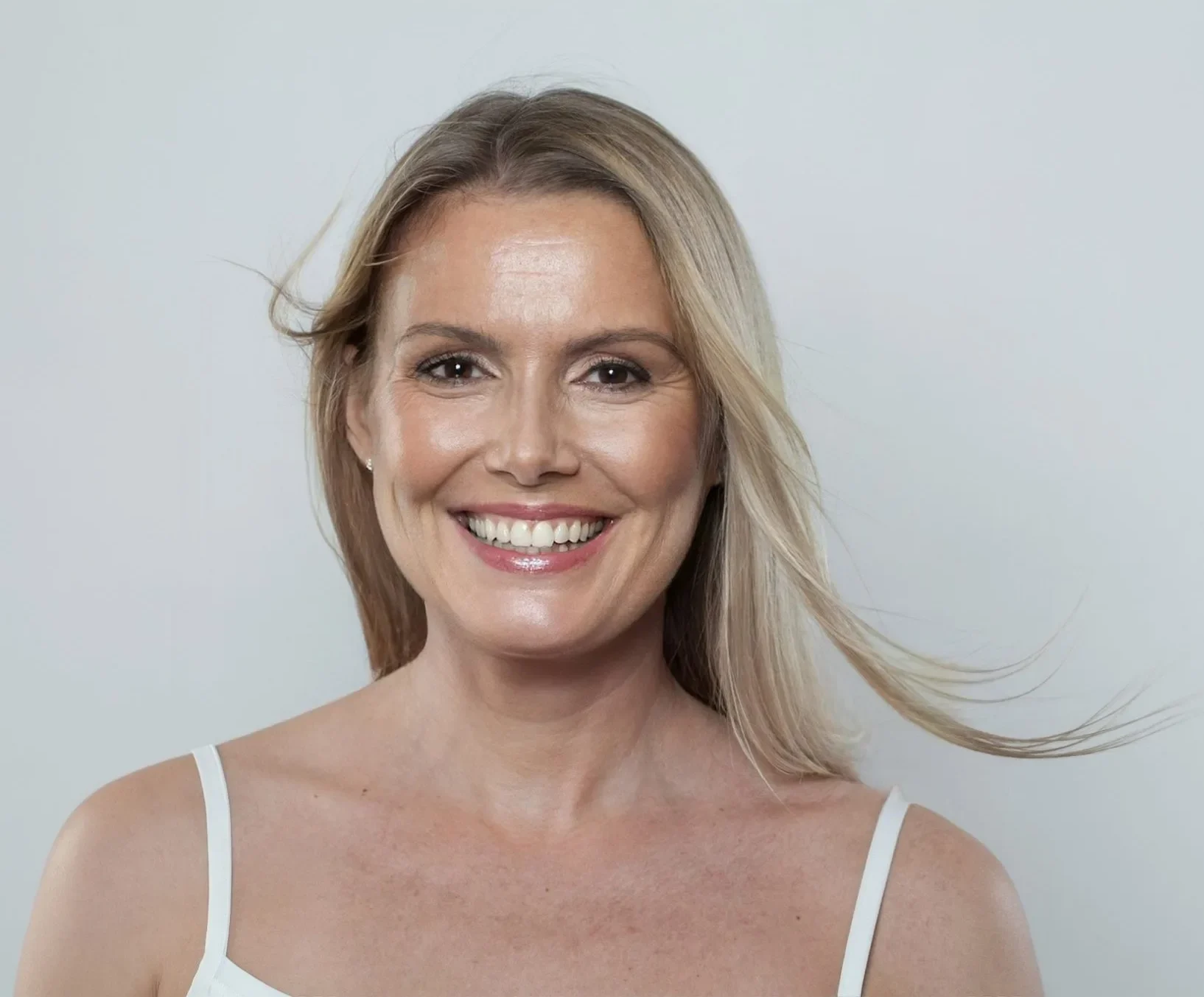 Smiling woman in her late thirties with blonde hair