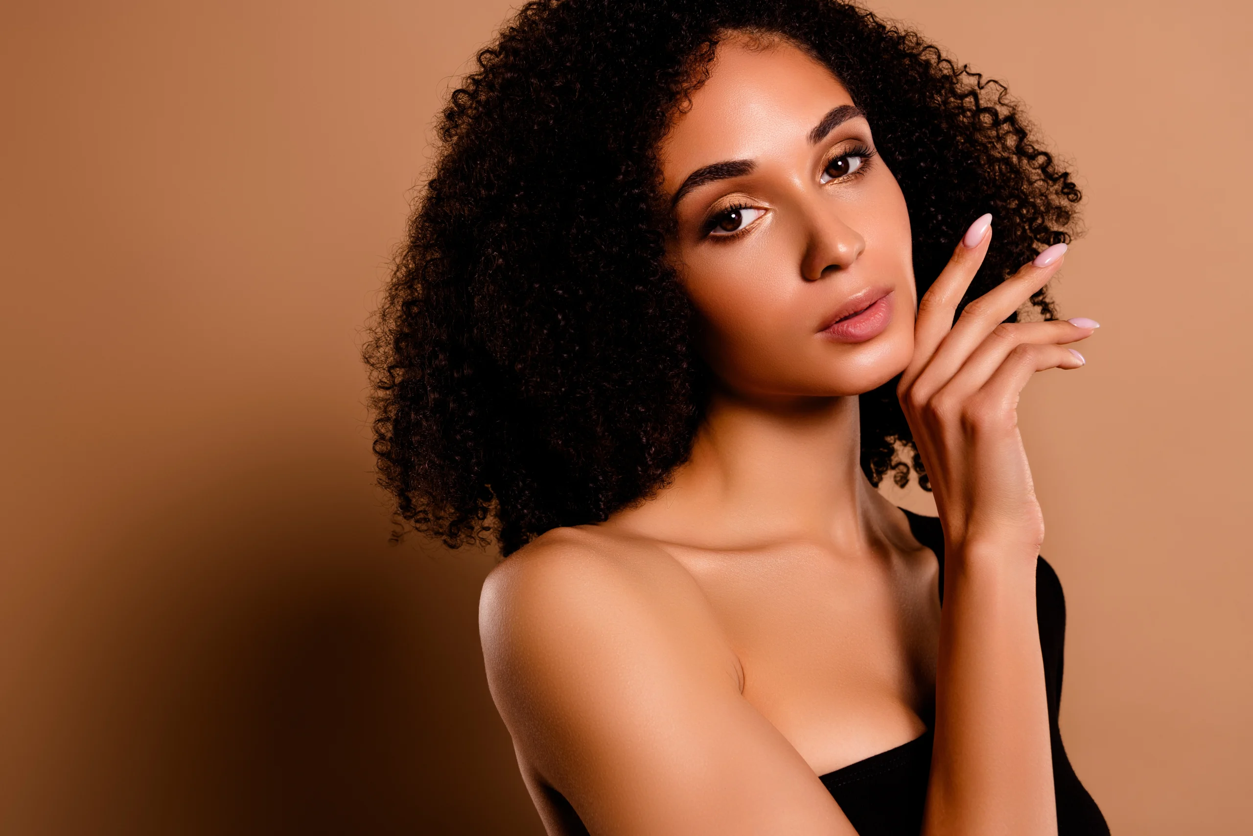 Woman with curly hair and radiant skin